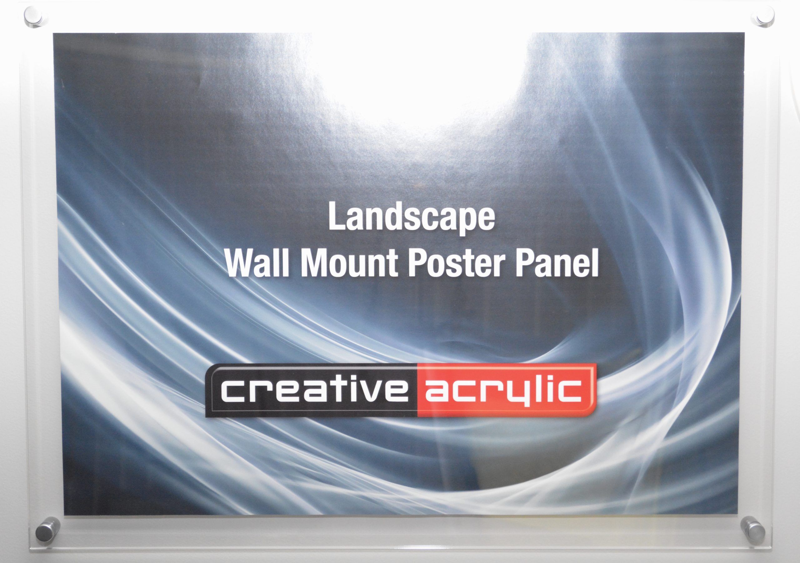 Clear acrylic wall mount poster trap that holds pages between two panels of acrylic, mounted to the wall