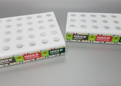 White acrylic fabricated lip balm displays with vinyl decals applied