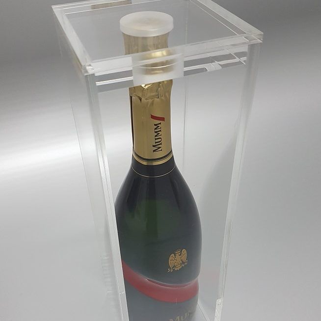 Clear acrylic wine display box housing a bottle of Mumm.
