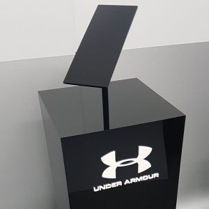 Black acrylic plinth Custom black acrylic plinth with angled display set on top. White acrylic logo adhered to the front face.