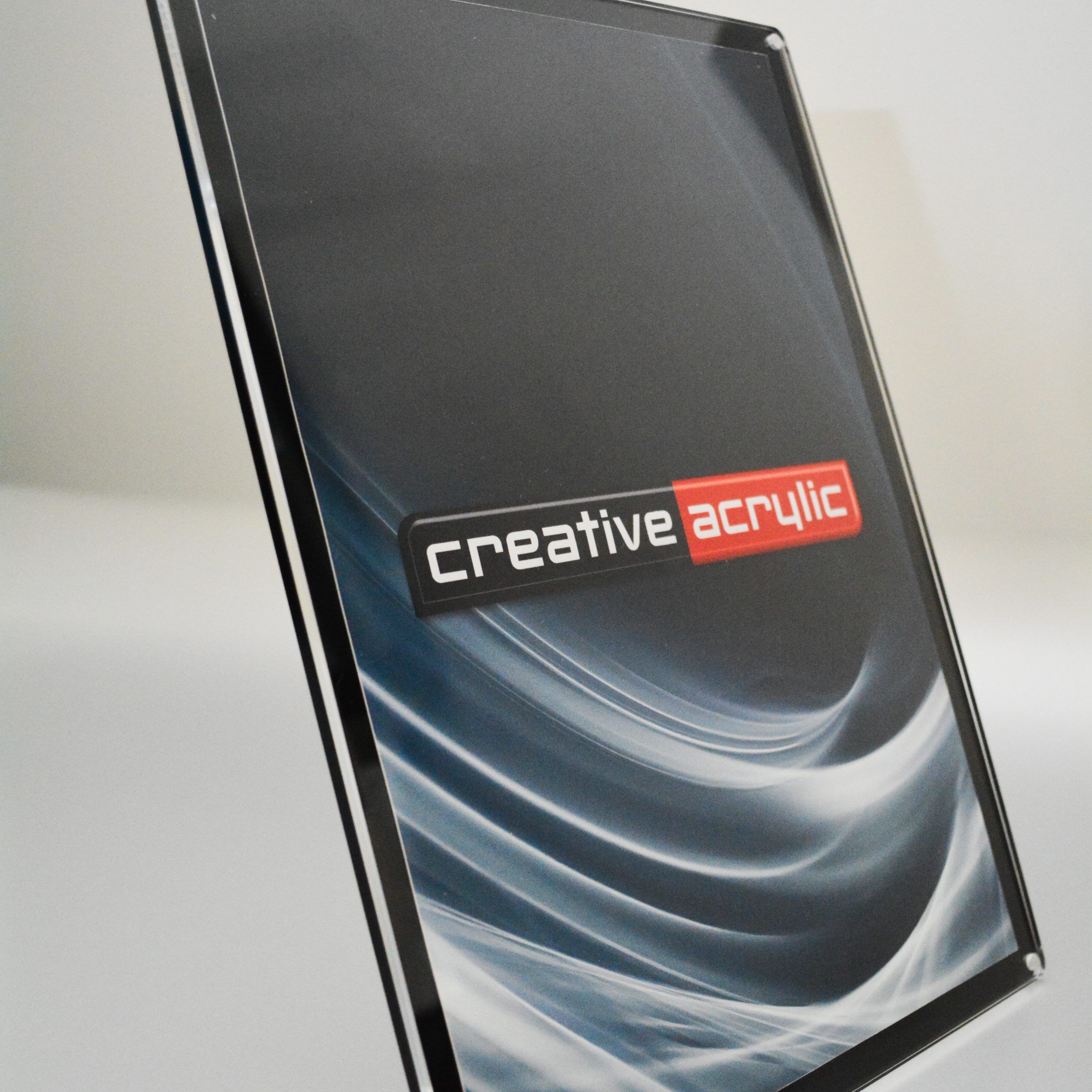 Slanted magnetic frames with black acrylic backing and clear acrylic front in portrait orientation