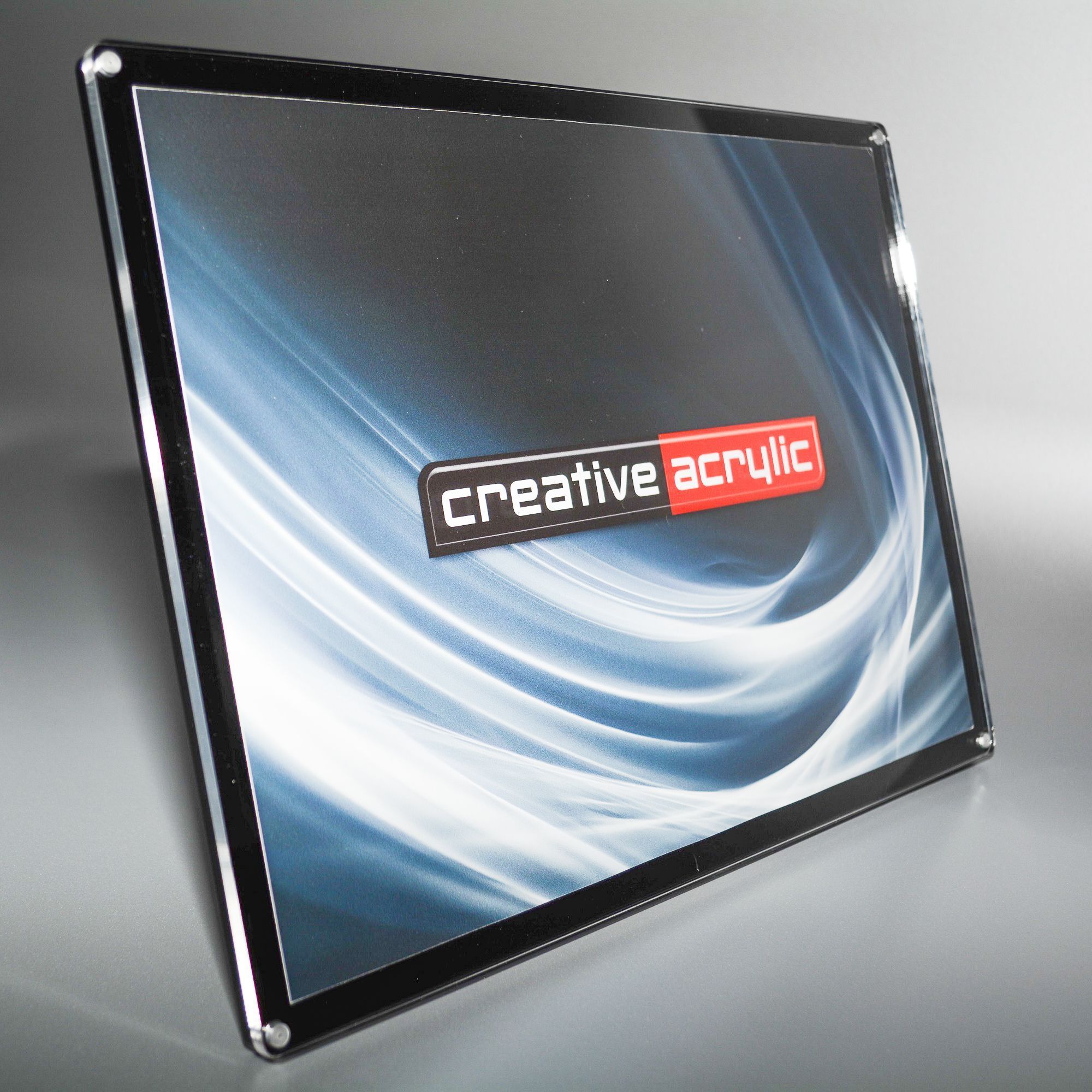 Slanted magnetic frames with black acrylic backing and clear acrylic front in landscape orientation
