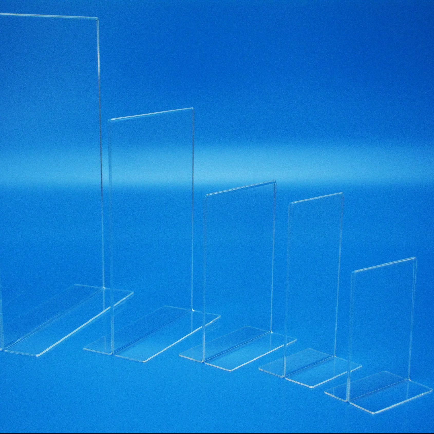 Portrait vertical menu holders manufactured in clear acrylic and showing a range of available sizes.