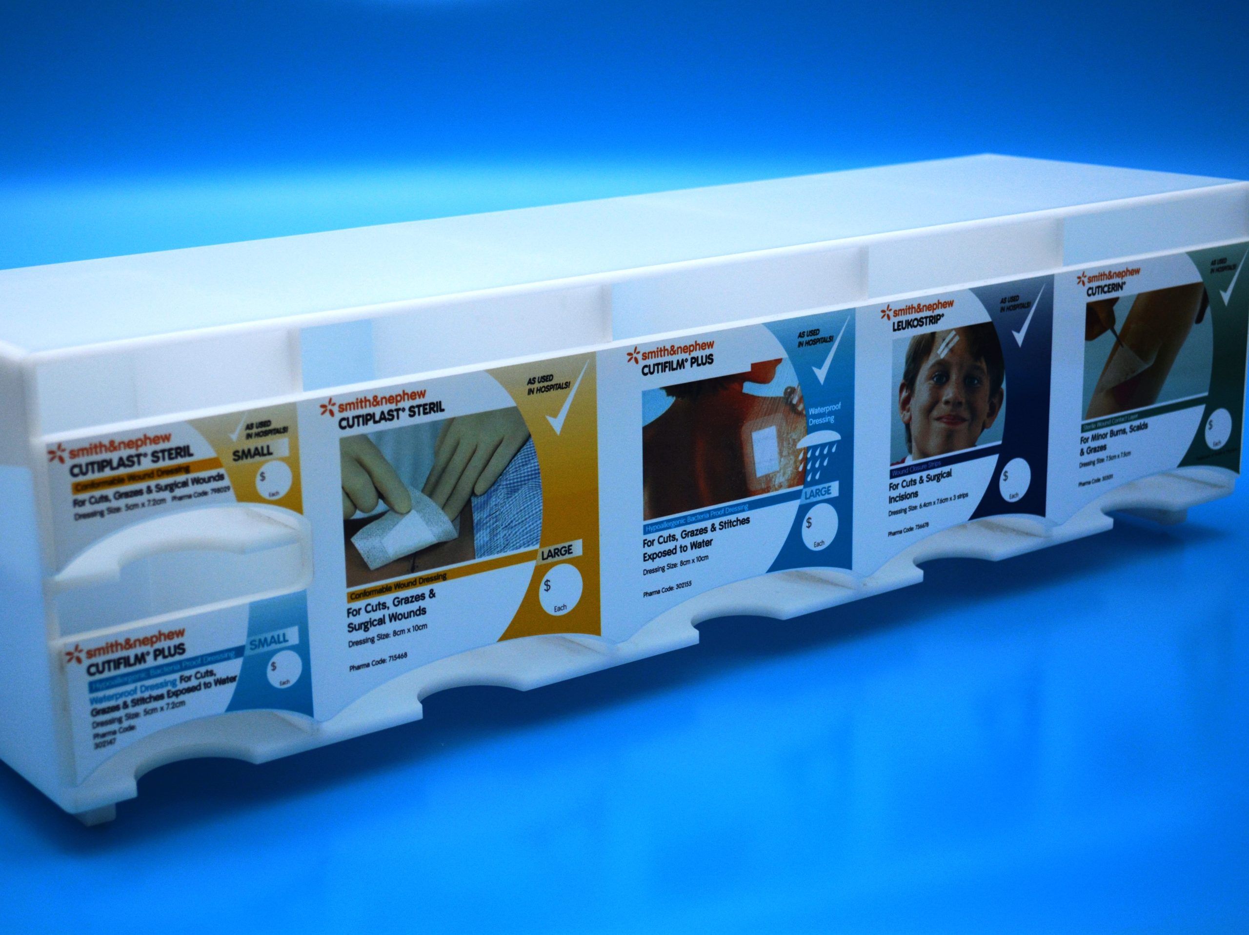 Opal acrylic shelf-top pharmacy stand with pockets to house wound dressings for purchase.
