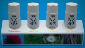 White acrylic cosmetic display stand with branding