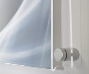 Corner/side view of an easy change graphic holder secured to the wall with a satin chrome sign mount