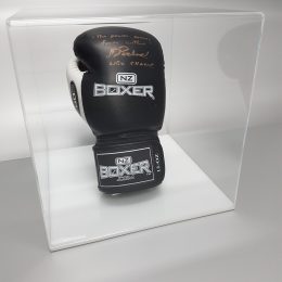 Clear acrylic disply cube with white base, housing a signed boxing glove
