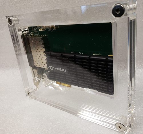Multiple panels of acrylic sandwiched together with chrome interscrews, housing a computer component