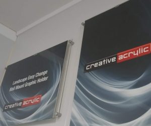 Easy change wall mounted poster traps, in clear acrylic, wall mounted and displaying images.