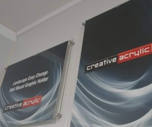 Easy change wall mounted poster traps, in clear acrylic, wall mounted and displaying images.