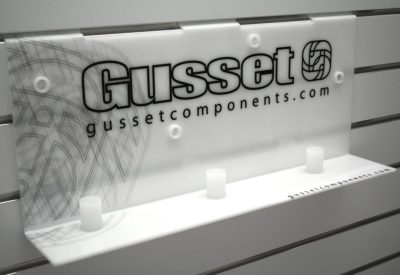 White acrylic slatwall display unit with custom graphics