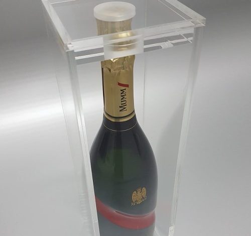 Clear acrylic wine display box housing a bottle of Mumm.
