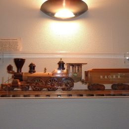 Clear acrylic custom display case with keyholes for wall mounting