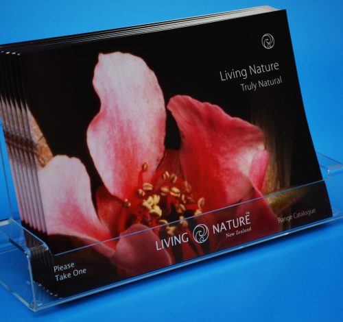 Custom acrylic brochure holder, displaying a customer's pamphlets with branding engraved on the front