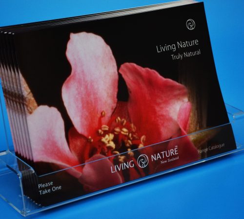 Custom acrylic brochure holder, displaying a customer's pamphlets with branding engraved on the front