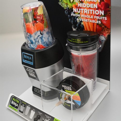 Acrylic shelf top display holding product, with a separate boxed section and pvc backing panel