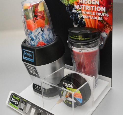 Acrylic shelf top display holding product, with a separate boxed section and pvc backing panel