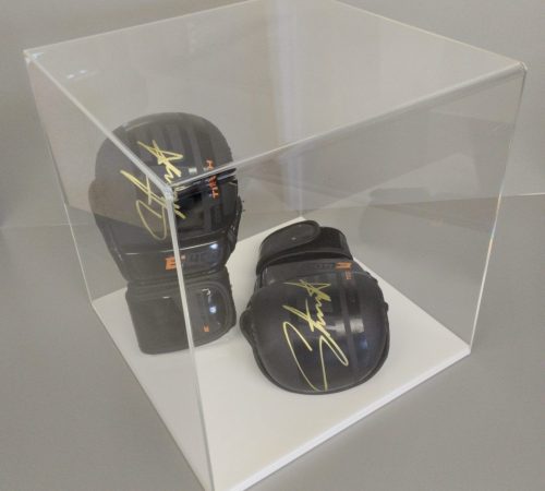 Clear acrylic 5-sided display cube on a white acrylic base, housing signed boxing gloves.