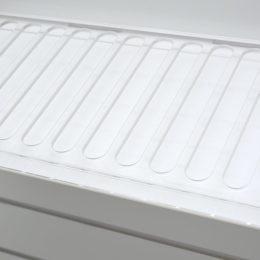 Opal acrylic slatwall display unit with a clear acrylic tray with slots to allow products to slide down to the front.