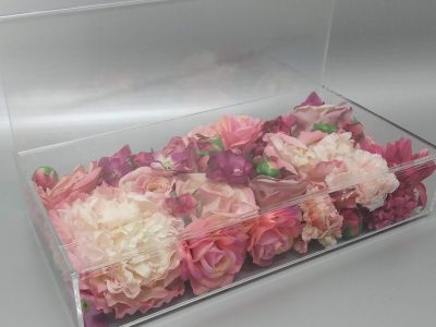 Custom made clear acrylic display stand with a hollow cavity filled with flowers.